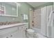 Cozy bathroom with white cabinet sink, toilet and shower with white tiled walls at 955 Eudora St # 708E, Denver, CO 80220