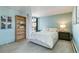 Serene bedroom with soft blue walls, a comfortable bed, a bookshelf, and a large window offering natural light at 955 Eudora St # 708E, Denver, CO 80220