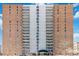 High-rise apartment building featuring brick facade and private balconies on each floor at 955 Eudora St # 708E, Denver, CO 80220
