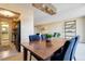 Cozy dining area featuring a wooden table with chairs, a modern light fixture, and views into the living room at 955 Eudora St # 708E, Denver, CO 80220