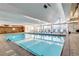 Well lit indoor pool with multiple lounge chairs and large glass window at 955 Eudora St # 708E, Denver, CO 80220