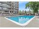 Outdoor swimming pool surrounded by lounge chairs and a fenced perimeter at 955 Eudora St # 708E, Denver, CO 80220