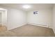 Cozy carpeted basement space featuring natural lighting and a neutral color scheme at 4470 W Lakeridge Rd, Denver, CO 80219