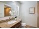 Granite-countered vanity in bathroom with tile flooring and natural light at 4470 W Lakeridge Rd, Denver, CO 80219