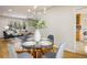 Dining area adjacent to the living room, featuring a glass table, and room for four at 4470 W Lakeridge Rd, Denver, CO 80219