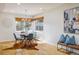 Bright dining area featuring a modern chandelier and a window with natural light at 4470 W Lakeridge Rd, Denver, CO 80219