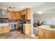 Bright kitchen features light wood cabinets, stainless appliances, tile backsplash, and tile flooring at 4470 W Lakeridge Rd, Denver, CO 80219