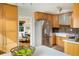 Well-lit kitchen with stainless steel appliances and bright, wooden cabinetry at 4470 W Lakeridge Rd, Denver, CO 80219