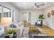 Cozy living room with a large window, hardwood floors, and neutral furnishings at 4470 W Lakeridge Rd, Denver, CO 80219