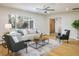 Bright living room featuring hardwood floors, neutral decor, and a large window at 4470 W Lakeridge Rd, Denver, CO 80219