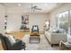 Inviting living room with hardwood floors, a ceiling fan, and bright, natural light at 4470 W Lakeridge Rd, Denver, CO 80219