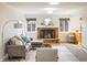 Comfortable living room with brick fireplace, modern furniture, and abundant natural light at 4470 W Lakeridge Rd, Denver, CO 80219