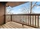 Balcony with wood floors, wooden railing, and a view of the neighborhood at 540 S Forest St # 6-203, Denver, CO 80246
