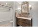 Bright bathroom featuring stylish vanity, decorative mirror, and tiled shower/tub combination at 540 S Forest St # 6-203, Denver, CO 80246