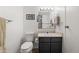 Standard bathroom with toilet, vanity and framed mirror with vanity lighting at 540 S Forest St # 6-203, Denver, CO 80246