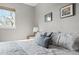 Bedroom featuring a large window with natural light and comfortable bedding with decorative pillows at 540 S Forest St # 6-203, Denver, CO 80246