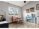 Cozy dining area featuring a large window, a dining table, and a shelving unit at 540 S Forest St # 6-203, Denver, CO 80246