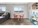 Cozy dining area features a small wooden table with seating and a comfortable gray couch at 540 S Forest St # 6-203, Denver, CO 80246