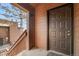 Private entrance featuring a staircase, balcony, and a secure front door at 540 S Forest St # 6-203, Denver, CO 80246