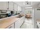 Kitchen with stainless steel sink and a view into the living room with a fireplace at 540 S Forest St # 6-203, Denver, CO 80246