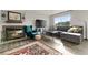 Cozy living room featuring a fireplace, comfortable seating, and a large area rug on gray tone wood flooring at 540 S Forest St # 6-203, Denver, CO 80246