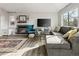 Comfortable living room featuring a fireplace, large sectional sofa, and lots of natural light from the large window at 540 S Forest St # 6-203, Denver, CO 80246