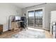 Bright office with a sliding glass doors to balcony, desk, and shelving at 540 S Forest St # 6-203, Denver, CO 80246