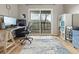 Bright office with a sliding glass doors to balcony, desk, and shelving at 540 S Forest St # 6-203, Denver, CO 80246