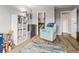 Cozy playroom with blue chair, wooden floors, and plenty of toy storage at 540 S Forest St # 6-203, Denver, CO 80246