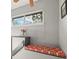 Cozy window seat with a red patterned cushion and a bright window view at 540 S Forest St # 6-203, Denver, CO 80246