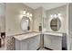 Elegant bathroom featuring double vanity with marble countertops and decorative patterned tile at 21541 Unbridled Ave, Parker, CO 80138