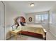 Bedroom with wooden bed frame, side table, and view to the outdoors at 21541 Unbridled Ave, Parker, CO 80138