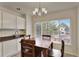 Cozy dining area with a wooden table and a large window providing ample natural light at 21541 Unbridled Ave, Parker, CO 80138