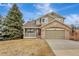 Charming two-story home featuring a stone facade, attached garage, and a well-maintained front yard at 21541 Unbridled Ave, Parker, CO 80138