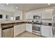 Bright kitchen featuring white cabinets, stainless steel appliances, and sleek countertops at 21541 Unbridled Ave, Parker, CO 80138