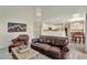 Comfortable living room featuring leather furniture, open access to kitchen and dining area at 21541 Unbridled Ave, Parker, CO 80138