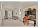Bright living room showcasing a sitting area, desk, and natural light from several large windows at 21541 Unbridled Ave, Parker, CO 80138
