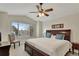 Inviting main bedroom featuring a large bed, serene view, and warm, neutral tones at 21541 Unbridled Ave, Parker, CO 80138