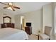 Comfortable main bedroom with a dresser, side chair, and adjacent bathroom access at 21541 Unbridled Ave, Parker, CO 80138