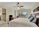Spacious main bedroom with a large window, en-suite bathroom, and a ceiling fan at 21541 Unbridled Ave, Parker, CO 80138