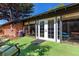 Brick house with access to sunroom, backyard, and artificial turf area at 6572 E Dakota Ave, Denver, CO 80224