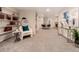 Open finished basement with bookshelves, seating, and brick fireplace at 6572 E Dakota Ave, Denver, CO 80224