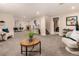 Spacious finished basement with seating areas, a brick fireplace, and neutral carpeting at 6572 E Dakota Ave, Denver, CO 80224