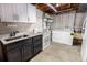 Basement featuring cabinetry, stainless steel appliances, a utility sink, and washer/dryer at 6572 E Dakota Ave, Denver, CO 80224