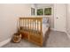 Cozy bedroom with natural light from the window and a charming wooden toddler bed at 6572 E Dakota Ave, Denver, CO 80224