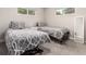 Bright bedroom with two twin beds, neutral decor, and carpeted floors at 6572 E Dakota Ave, Denver, CO 80224