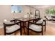 Elegant dining room features a stylish table with seating and sleek hardwood flooring at 6572 E Dakota Ave, Denver, CO 80224