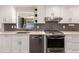 Bright kitchen featuring white cabinets, stainless steel appliances, and contemporary countertops at 6572 E Dakota Ave, Denver, CO 80224