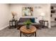 Comfortable living room area features a gray sofa, colorful art, and stylish round tables at 6572 E Dakota Ave, Denver, CO 80224