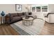 Cozy living room features a comfortable sectional sofa, stylish rug, and plenty of natural light at 6572 E Dakota Ave, Denver, CO 80224